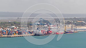 Aerial view of various containers stored in the container terminal near water timelapse, Setubal, Portugal
