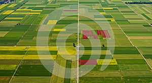 Aerial view of a vast agricultural landscape featuring a patchwork of rectangular fields photo