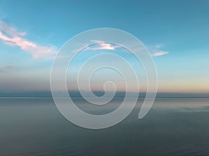 Aerial view of a vast lake during dawn with a clear blue sky