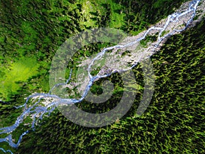 Aerial view of vast river valley in the mountains overgrown with dense forest. Hunting and National Park and wildlife reserve