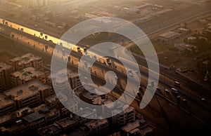 Aerial view of vehicles driving on a highway at sunset. Cairo, Egypt