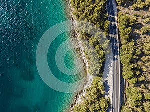 Aerial view of vehicles driving on a road along the wild coastline near Zadar, Croatia