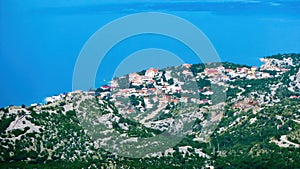 Aerial view from velebit mountains on valley with village of Karlobad, meditarranean sea background - Croatia photo