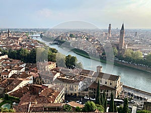 Aerial view of Verona, Italy. Historical city center, medieval buildings with red tiled roofs and bridges across Adige river.