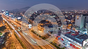 Aerial view of Via Expresa highway and metropolitan bus with traffic day to night timelapse. Lima, Peru