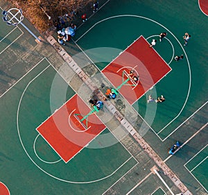 Aerial view of a vibrant basketball court with teams playing a competitive game