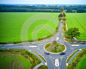 Aerial view of the view over a small traffic circle in a rural environment with few cars