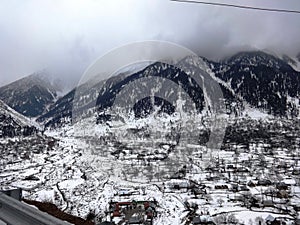 An aerial view of a village covered with snow in Srinagar