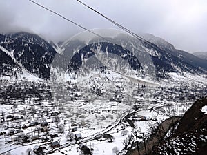 An aerial view of a village covered with snow in Srinagar, India