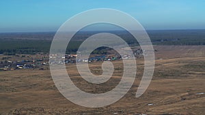 Aerial view of the village among fields and forests