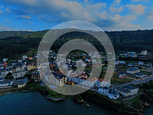 an aerial view of the village and harbor of a small fishing village