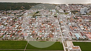 Aerial view of the Village next to the green paddy field in Sekinchan, Selangor, Malaysia