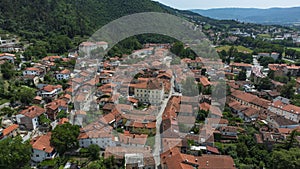 Aerial View of Vipava Town, Slovenia. Red Roofs and Forest Covered Hills in the Background