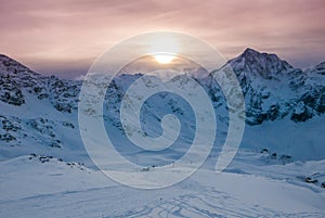 Aerial view of vivid beautiful sunset over snowy ski resort