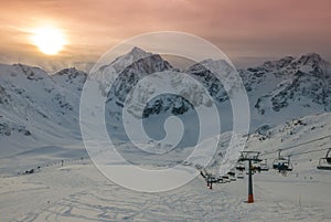 Aerial view of vivid beautiful sunset over snowy ski resort