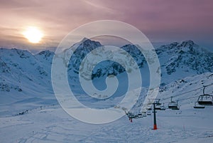 Aerial view of vivid beautiful sunset over snowy ski resort