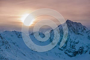 Aerial view of vivid beautiful sunset over windy winter mountians