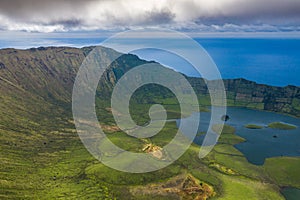 Aerial view of volcanic crater Caldeirao with a beautiful lake on the top of Corvo island. Azores islands, Portugal