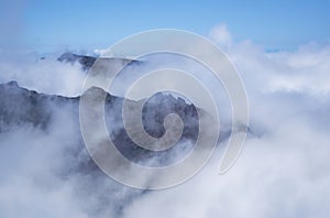 Aerial view of volcanic peaks emerging from the clouds, Pico do Arieiro, Madeira Portugal