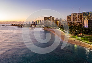 Aerial view of Waikiki beach towards Honolulu at sunset