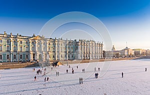 Aerial view of walking people on frozen the Neva River in Saint Petersburg at sunny frosty day, Peter and Paul Fortress