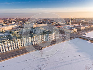 Aerial view of walking people on frozen the Neva River in Saint Petersburg at sunny frosty day, Peter and Paul Fortress