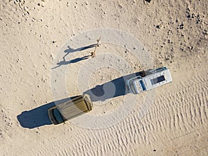 Aerial view of wanderlust people couple of women enjoying the travel with old van together - summer holiday alternative vacation