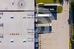 Aerial view of warehouse storages or industrial factory or logistics center from above. Aerial view of industrial buildings and