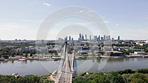 Aerial view of Warsaw cityscape with skyscrapers and bridge over river