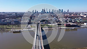 Aerial view of Warsaw current urban landscape on bank of Vistula and Swietokrzyski Bridge over river on sunny day
