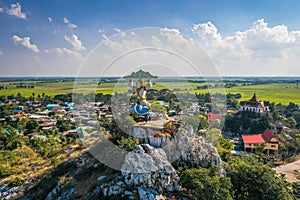 Aerial view of Wat Khao Samo Khon temple, with hanuman monkey god statue on top of mountain, in Lopburi, Thailand photo