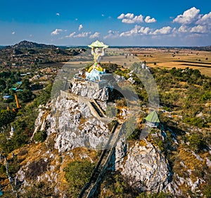 Aerial view of Wat Khao Samo Khon temple, with hanuman monkey god statue on top of mountain, in Lopburi, Thailand photo