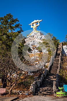 Aerial view of Wat Khao Samo Khon temple, with hanuman monkey god statue on top of mountain, in Lopburi, Thailand photo