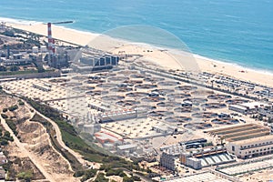 Aerial view of a water reclamation plant and beach on the Pacific Ocean