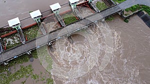 Aerial view of the water released from the concrete dam\'s drainage channel as the overflow in the rainy season.
