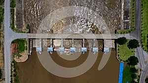 Aerial view of the water released from the concrete dam`s drainage channel as the overflow in the rainy season. Top view of turbi