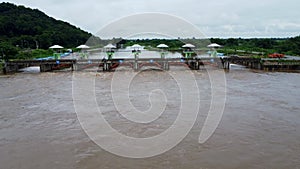 Aerial view of the water released from the concrete dam`s drainage channel as the overflow in the rainy season. Top view of turbid