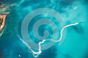 Aerial view of watercrafts speeding up on the ocean