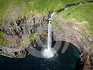 Aerial view of waterfall falling from the cliff into the sea, Denmark, Faroe Islands, Vagar Island, Gasadalur photo