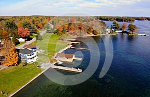 The aerial view of the waterfront homes with private docks surrounded by stunning fall foliage near Wellesley Island, New York, U.
