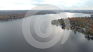 Aerial view of waterfront houses on a lake in late autumn
