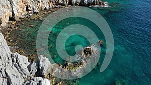 Aerial view of the waves breaking on the cliffs of the rocks On the coast of