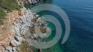 Aerial view of the waves breaking on the cliffs of the rocks On the coast of