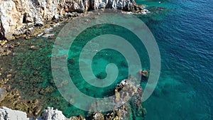 Aerial view of the waves breaking on the cliffs of the rocks On the coast of