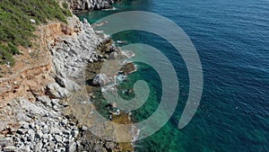 Aerial view of the waves breaking on the cliffs of the rocks On the coast of