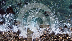 Aerial view of waves breaking on the rocks. Drone shote of sea