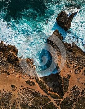 Aerial view of waves crashing against the coastline