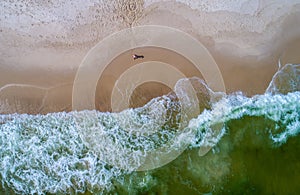 Aerial view of the waves crashing on the beach at Perdido Key beach in Pensacola Florida