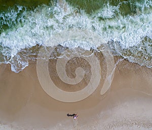 Aerial view of the waves crashing on the beach at Perdido Key beach in Pensacola Florida