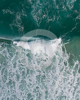 Aerial view of a waves crashing and rolling in the ocean